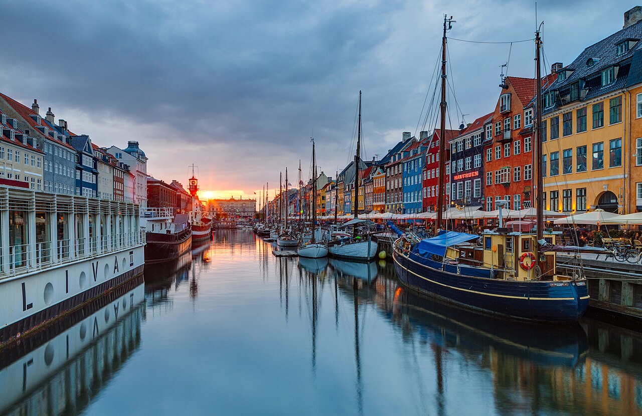 Coloured townhouses and wooden boats along the Nyhavn canal in Copenhagen