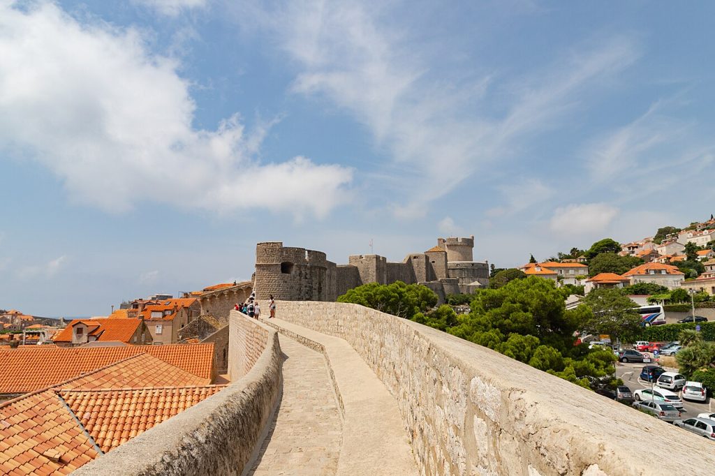 The walled old town of Dubrovnik with orange roofs above the Adriatic