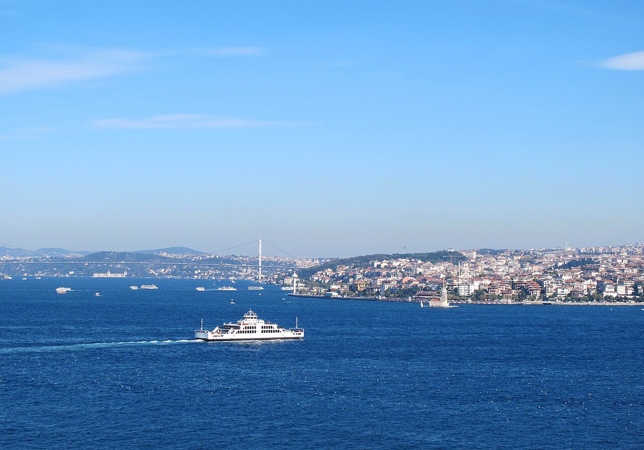 A passenger ferry crossing the Bosphorus with the hills of the Asian shore behind