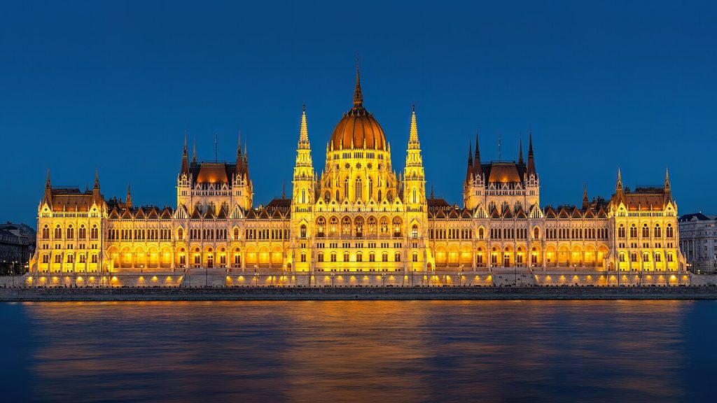 The Hungarian Parliament Building along the Danube, its neo-Gothic spires and dome reflected in the water