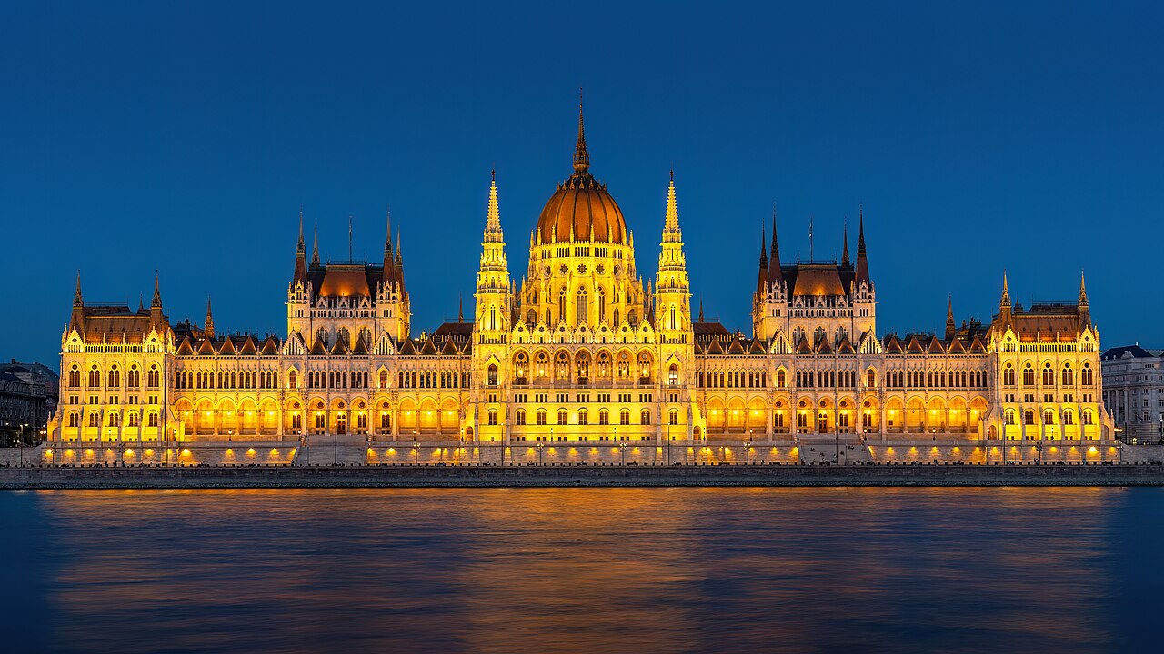 The Hungarian Parliament Building along the Danube, its neo-Gothic spires and dome reflected in the water