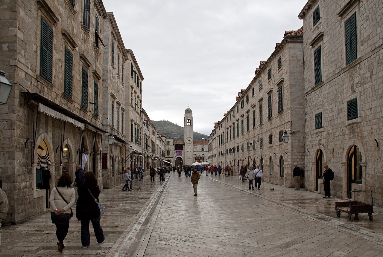 The wide limestone-paved main street of Dubrovnik lined with shuttered stone buildings