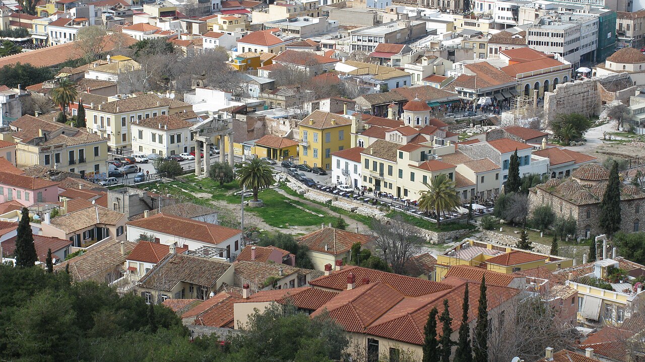 A narrow Plaka street with neoclassical houses, bougainvillea and tables set outside