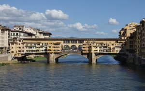 The Ponte Vecchio with its overhanging shops, seen along the Arno