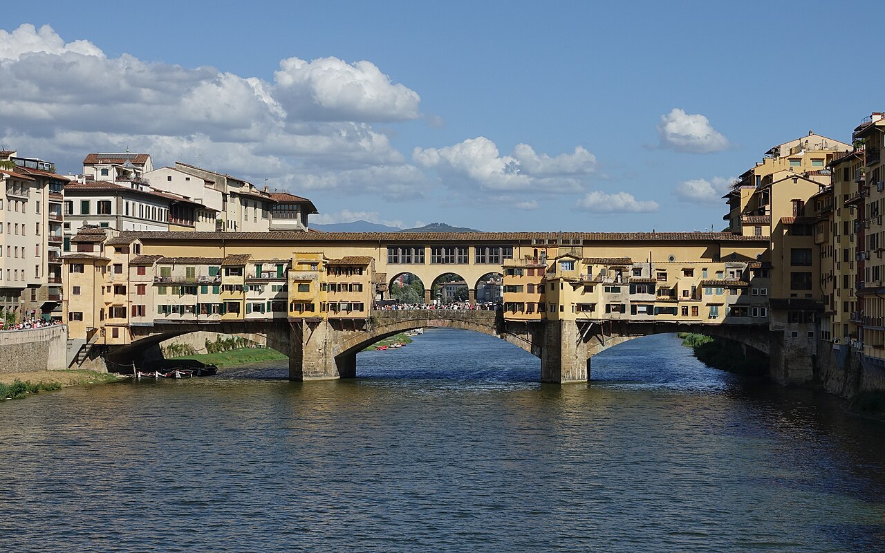 The Ponte Vecchio with its overhanging shops, seen along the Arno