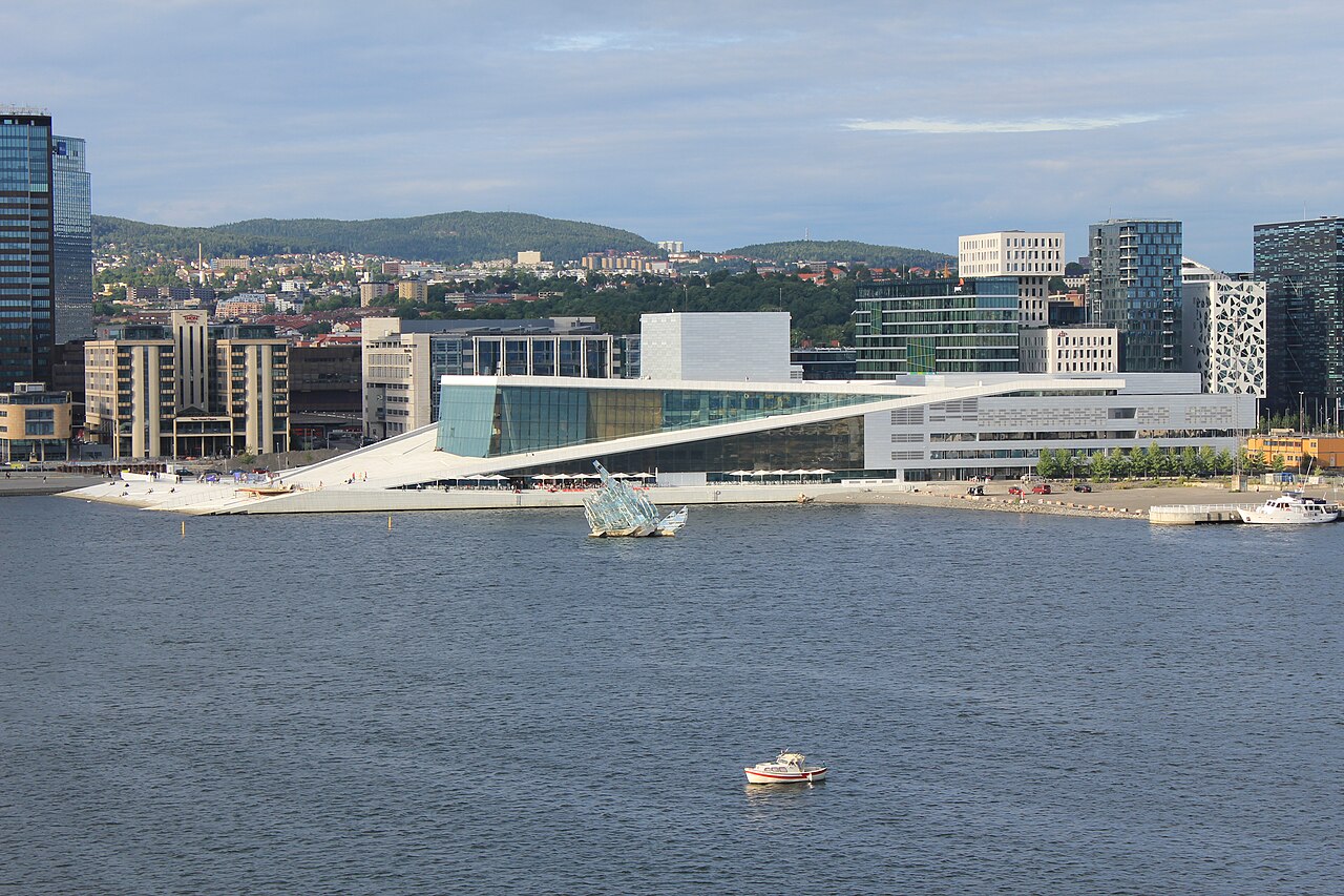 A white marble opera house sloping into the fjord with people walking on its roof