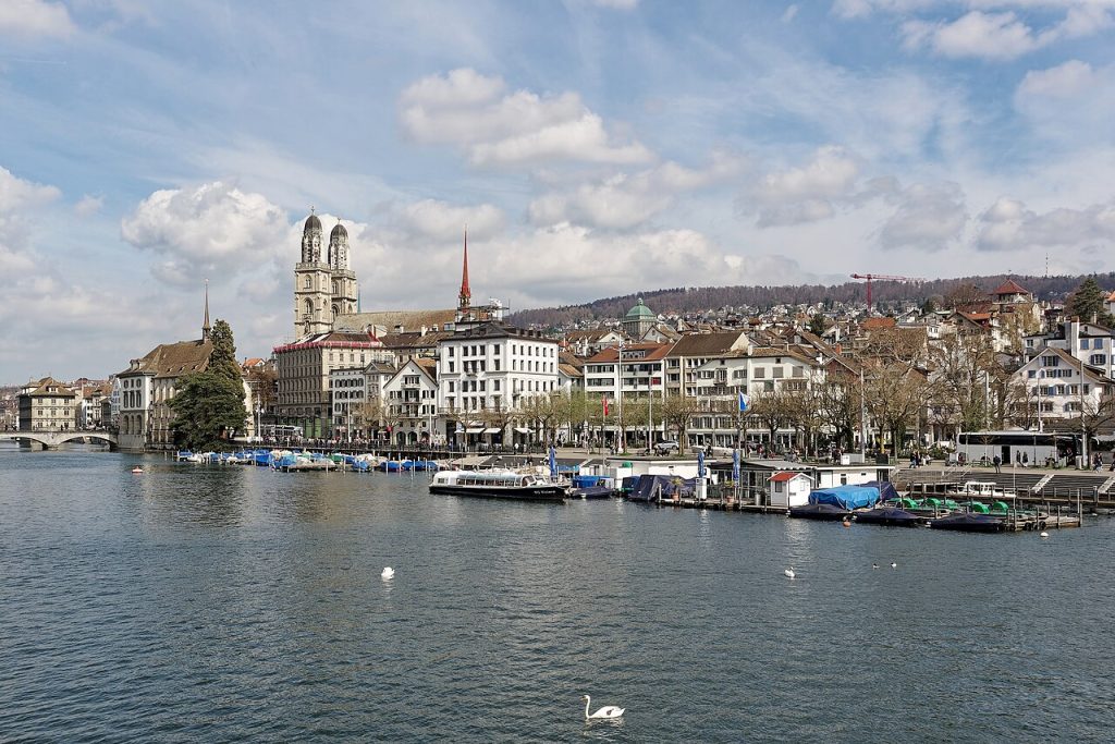 A wooden bathing pavilion built out over the green Limmat river in Zurich