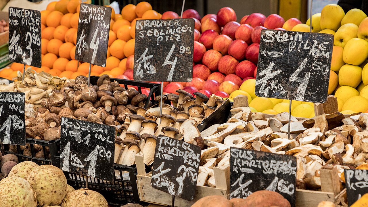 Stalls of olives, dried fruit and spices under awnings at the Naschmarkt