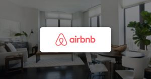 Airbnb logo over a bright apartment living room