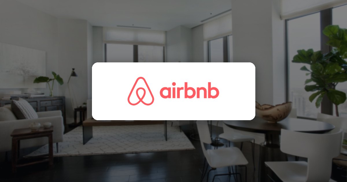 Airbnb logo over a bright apartment living room